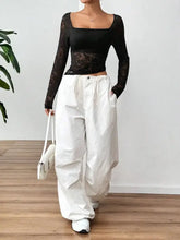 Black lace long sleeve top with white cotton wide-leg pants