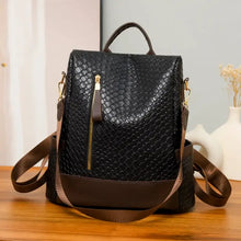 Black faux leather backpack bag with brown straps, gold hardware, scale texture