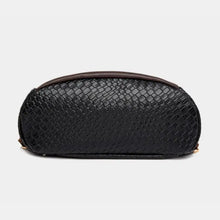 Black woven leather backpack bag with rounded bottom, brown straps, gold hardware