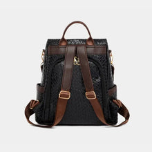Black leather backpack bag with brown straps and gold hardware