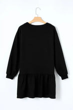 Black long-sleeved dress with ruffled hem, round neckline, and shamrock beer print