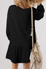 Black long sleeve dress with ruffled hem, shamrock print, and crossbody bag