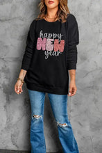 Black long sleeve round neck sweatshirt with glittery pink and blue Happy New Year print on distressed jeans