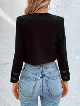 Black sheer mesh long-sleeve crop top with high waist jeans