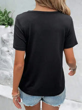 Woman in black neckline short sleeve t-shirt and blue denim shorts