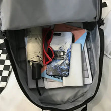 Black oxford cloth backpack with adjustable straps and essentials inside