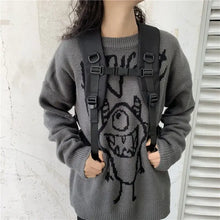 Gray knitted sweater with black monster and oxford cloth backpack with adjustable straps