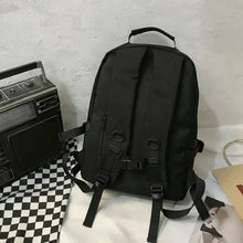 Black Oxford cloth backpack with adjustable straps and compartments