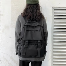 Black oxford cloth backpack with adjustable straps and multiple pockets
