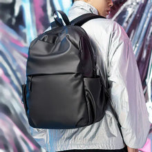 Black oxford cloth waterproof backpack with minimalist matte finish and compartments