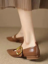 Black patent point toe Mary Jane flats with gold buckle