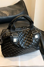 Quilted black faux leather handbag with top handles and silver hardware