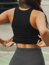 Black ribbed stretch racerback crop top with gold chain detail and bracelet
