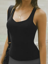 Black ribbed stretch scoop-neck tank top with thin straps and layered necklaces