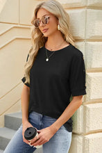 Women’s black round neck buttoned short sleeve top with cut-out shoulders