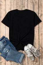 Black sequin bow pattern t-shirt with leopard sneakers and jeans