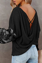 Black sequin puff sleeve top with bell sleeve length and crisscross back