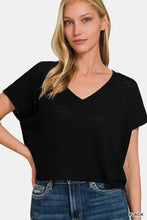 Woman in black short sleeve crop t-shirt and blue jeans