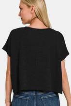 Women’s black short sleeve crop t-shirt paired with blue jeans