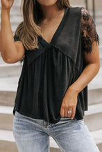 Black short sleeve lace babydoll top with v-neck and ruffled hem