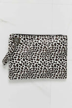 Animal print wristlet with leopard spots on black short-sleeve mini dress