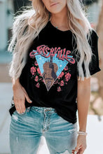 Black short-sleeved t-shirt with Nashville graphic and distressed jeans