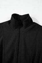 Black sleeveless zip mini dress with drawstring waist and textured jacket