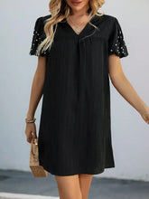 Black stretch polka dot puff sleeve dress with ruffles and pockets
