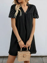 Black stretch polka dot puff sleeve dress with ruffles and pockets