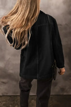 Black denim jacket with pockets, button closure, fringe, and lace-up details