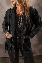 Black denim jacket with button front, pockets, fringe, and lace-up details