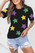 Women’s slightly stretchy black t-shirt with colorful star pattern and denim shorts