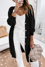 Black textured cardigan with gold buttons and long sleeve length