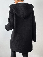 Black textured sherpa hooded coat with long sleeves and pockets