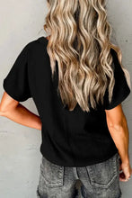 Black textured V-neck short sleeve blouse with cuffed sleeves