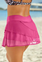 Black tiered swim skirt in solid pattern with chiffon ruffles