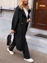 Oversized black wool coat with white collar, gold buttons, wide lapels, and pockets