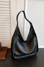 Black woven leather shoulder bag with snakeskin texture and single strap