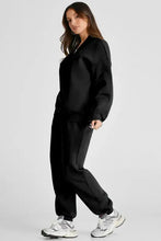 Black zip-up tracksuit with full length joggers, oversized sweatshirt, white sneakers