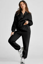 Black zip-up tracksuit with drawstring waist and full length joggers