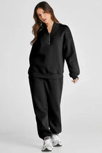 Black zip-up tracksuit with drawstring waist and full length joggers