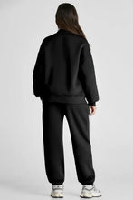 Black zip-up tracksuit with drawstring waist and full length joggers
