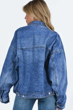 Blue acid wash denim jacket with button closure and oversized pockets