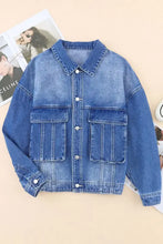 Light blue acid wash denim jacket with oversized pockets and button closure