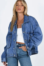 Blue acid wash denim jacket with oversized pockets and button closure