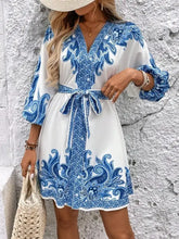 Blue and white floral print dress with V-neckline and tie waist