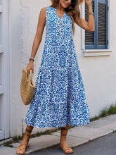 Blue and white floral maxi dress with decorative button and ruffled hem