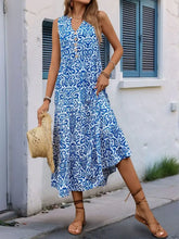 Blue and white floral maxi dress with decorative button and ruffled hem