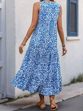 Blue and white floral maxi dress with decorative button and ruffled hem