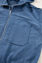 Blue corduroy hoodie with hood, zipper closure, and pockets